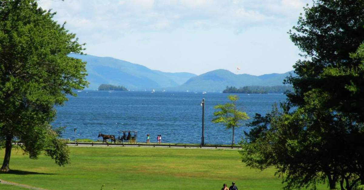 Lake George Battlefield Park overlooking Lake George with Adirondack Mountains and lakeside walking path