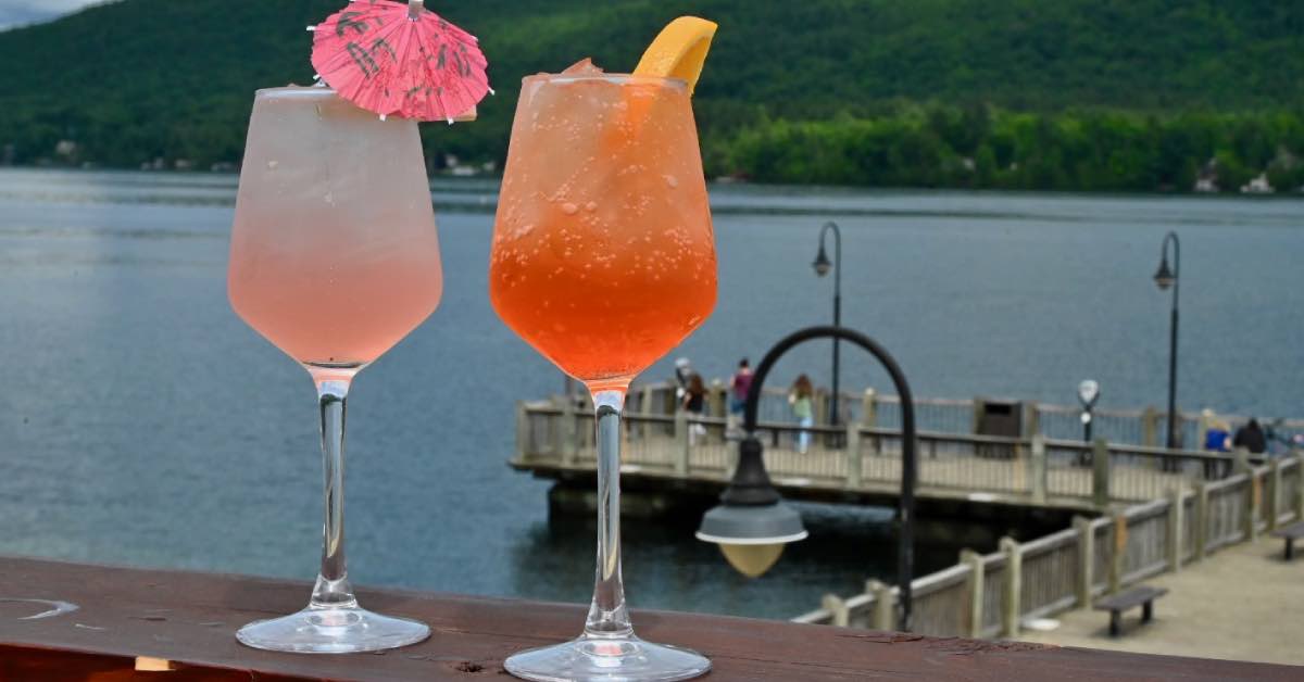 Colorful cocktails at Lake George Beach Club overlooking the water and nearby dock