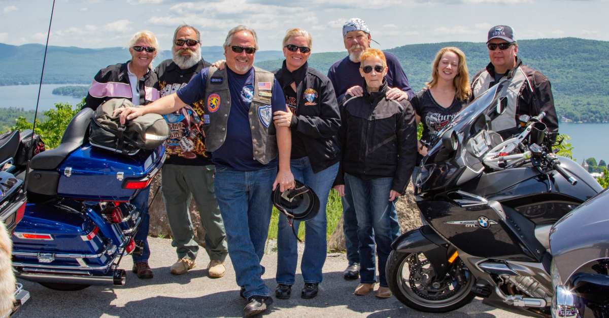 a happy group of people with motorcycles