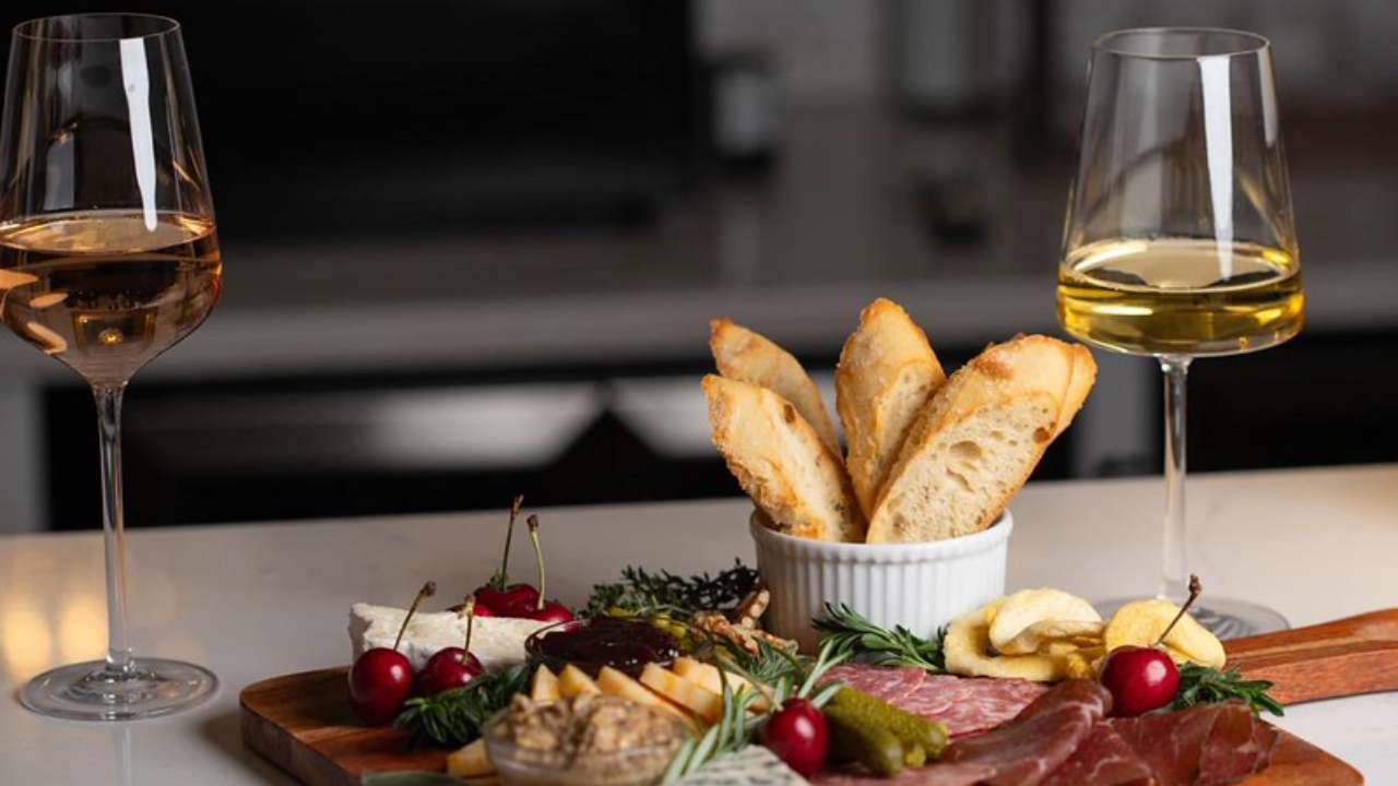 two glasses of wine and charcuterie 