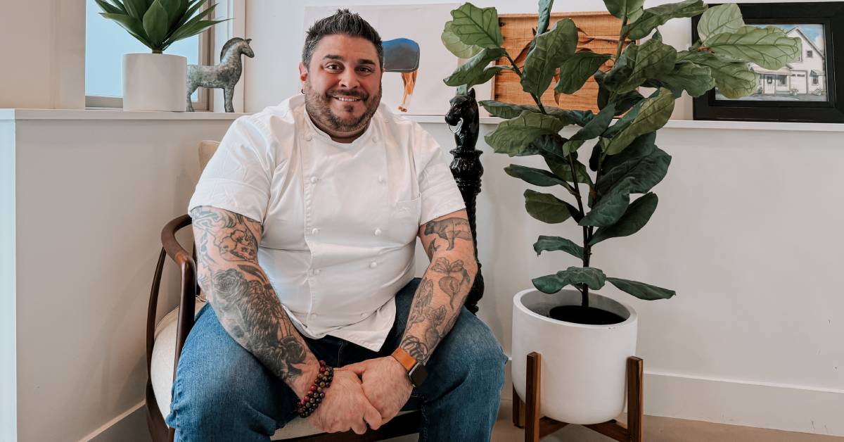 chef mike posing by a plant