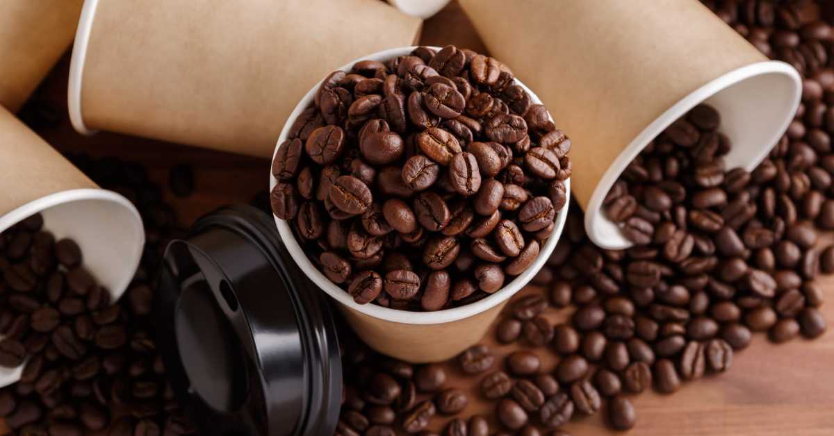 coffee beans in a coffee cup and on a table