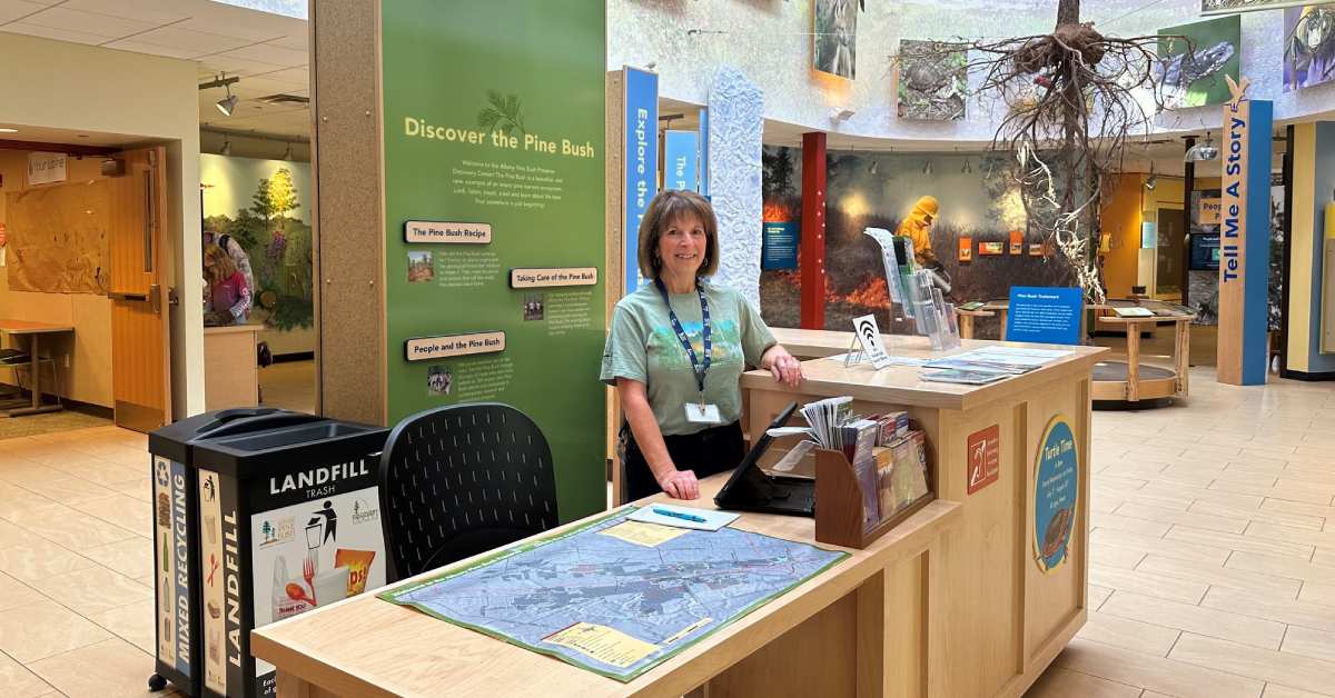 woman at front desk of The Discover Center at Albany Pine Bush preserve