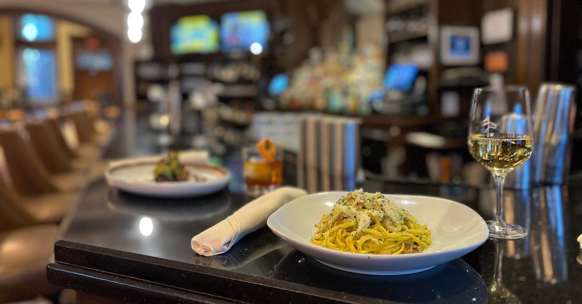 food and wine and cocktail on a bar counter