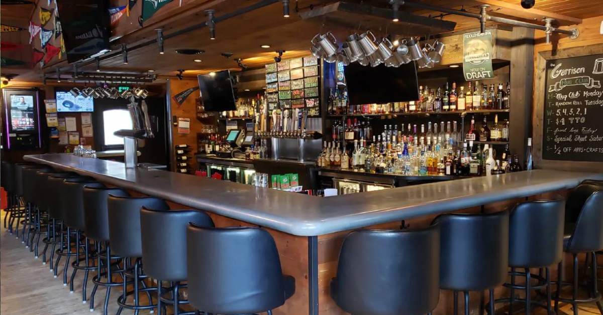 The Garrison restaurant bar on Beach Road in Lake George with cozy Adirondack-style interior and seating
