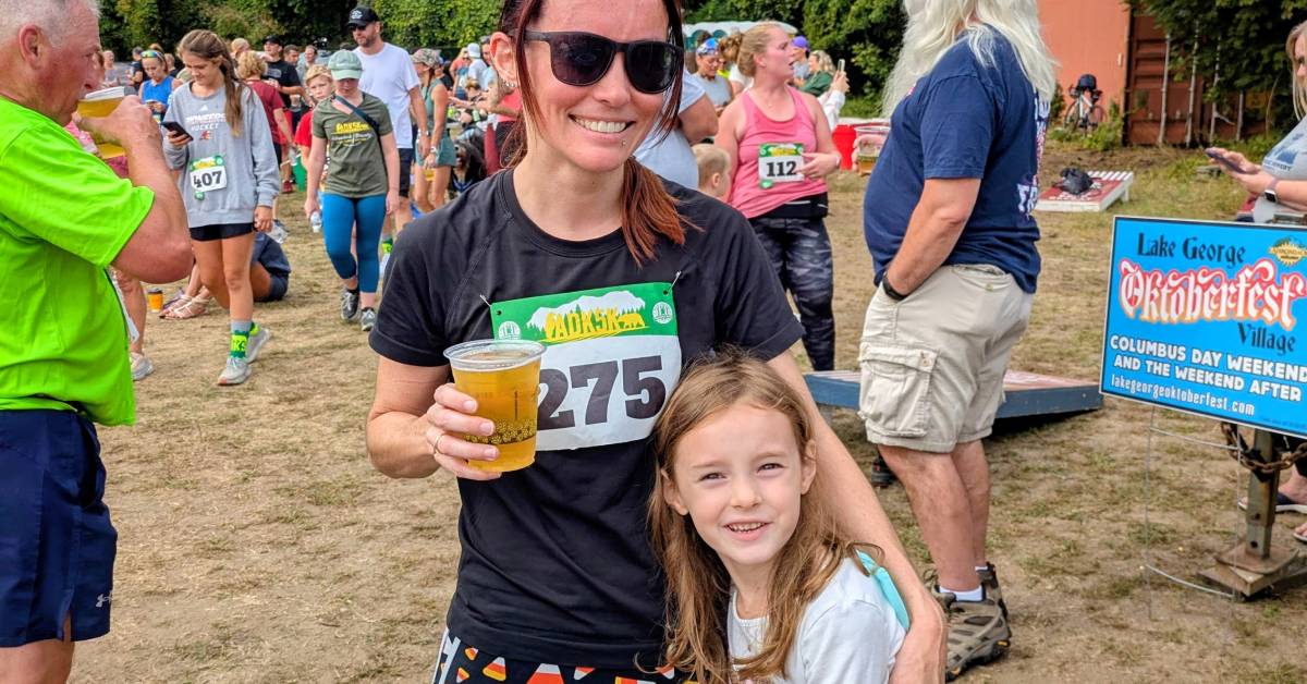runner with beer poses with daughter