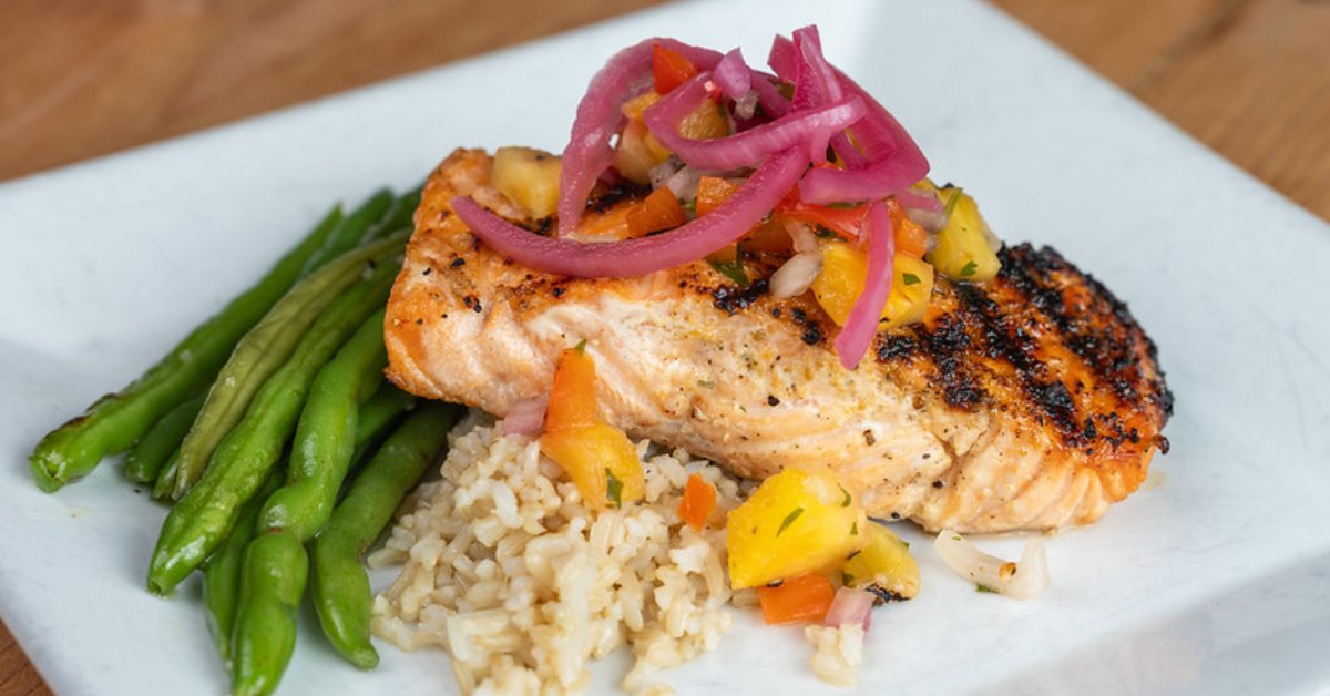grilled salmon over rice with vegetables