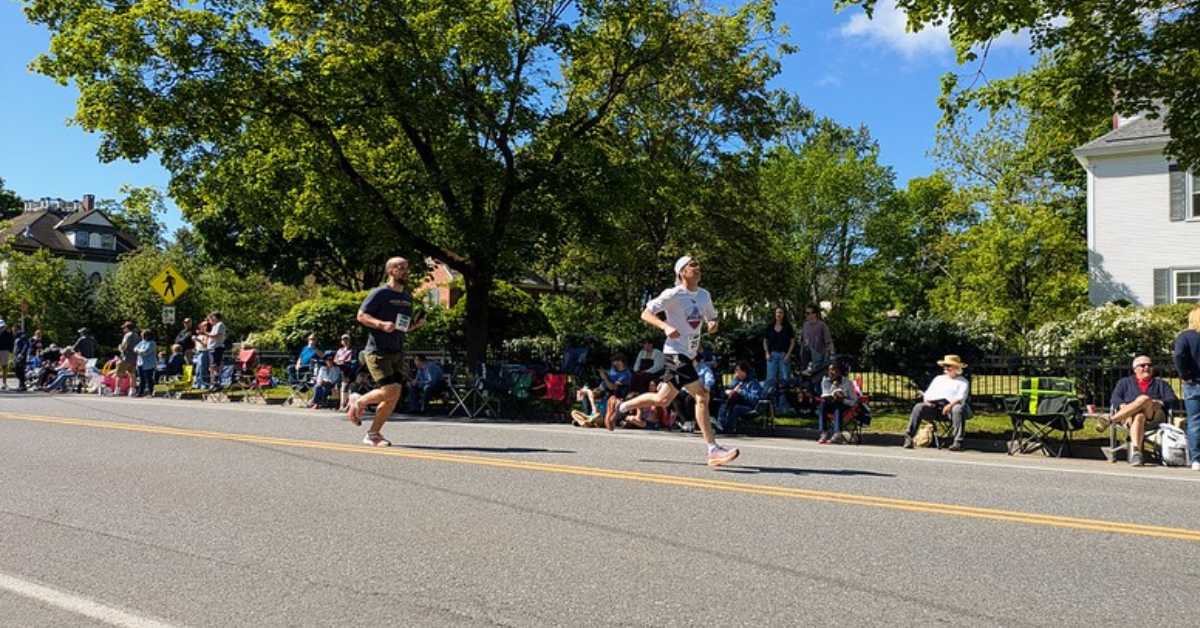 two runners racing down a road