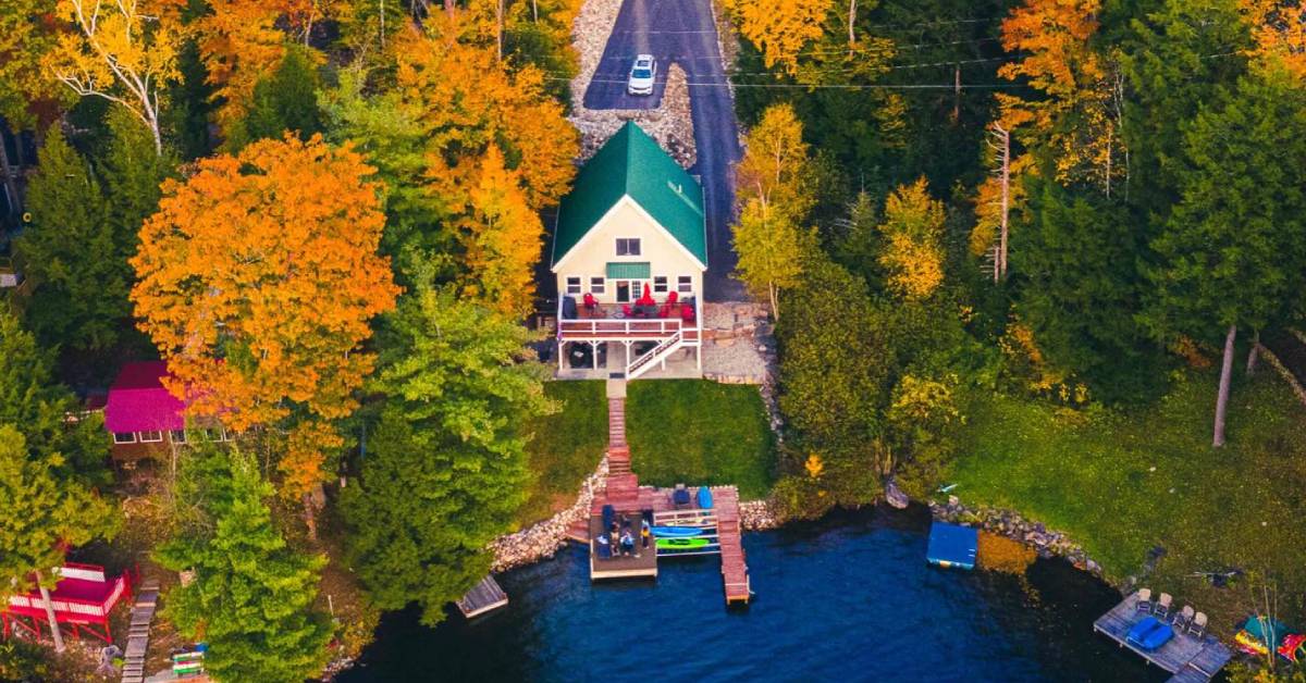 aerial view of vacation rental home on lake in the fall