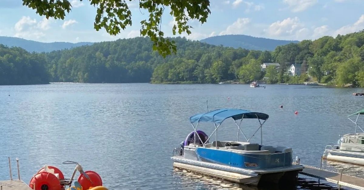 a boat in the water with the mountains in the background