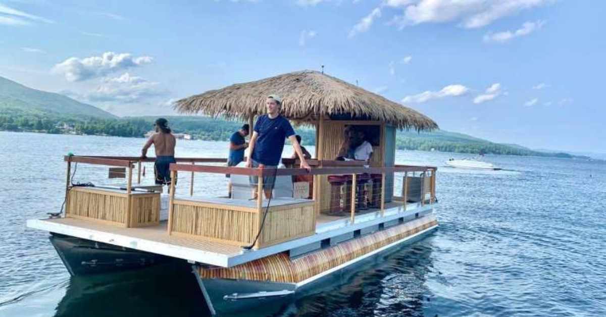 tiki boat with people on it in the middle of the lake