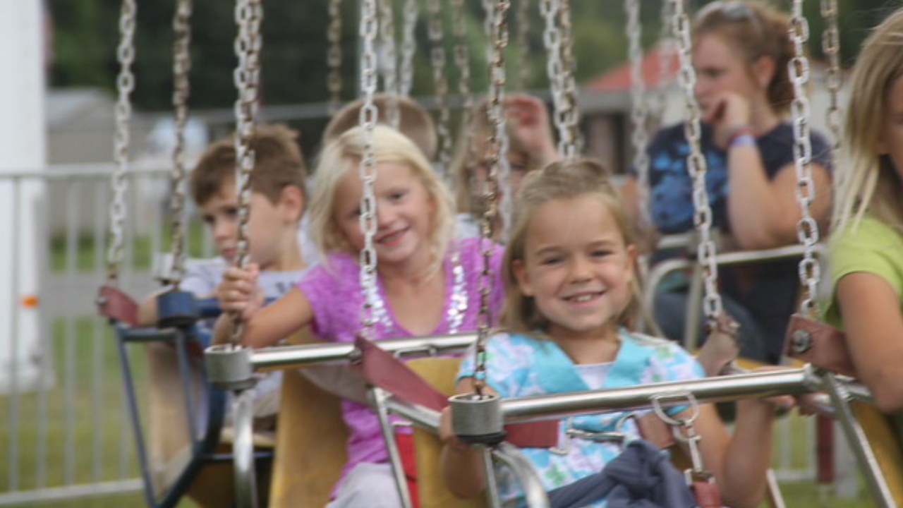kids on swing ride at fair