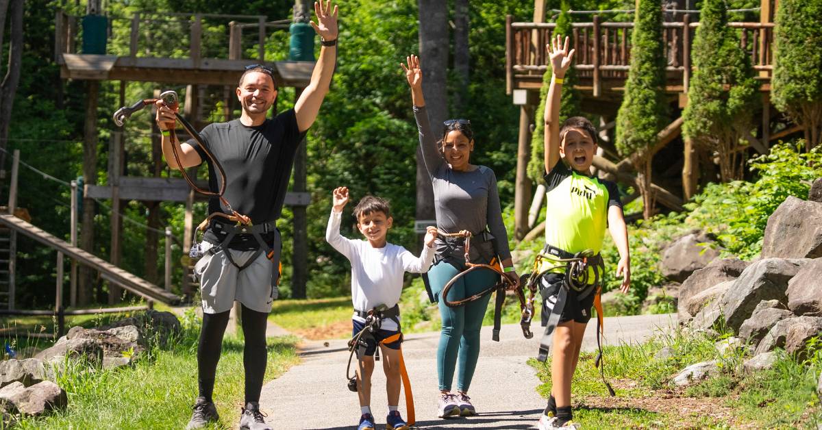 family of four excited to go on a treetop course