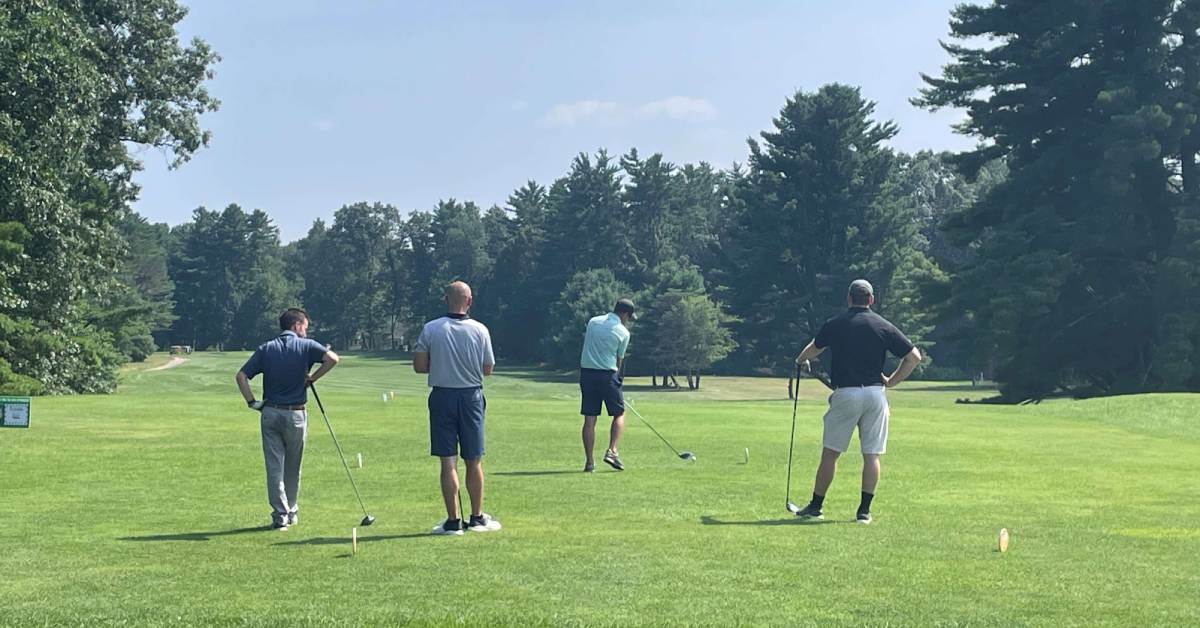 four men on a golf course