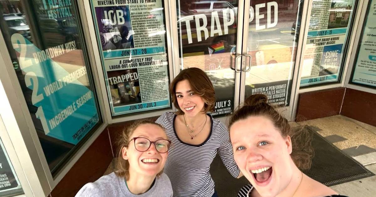 women excited to go into theater festival