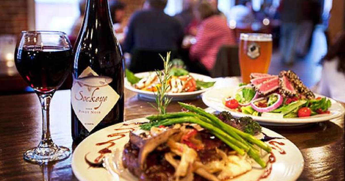 dishes on table with bottle of wine