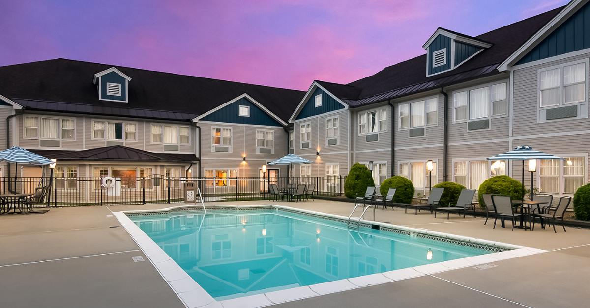 an outdoor pool near a hotel building