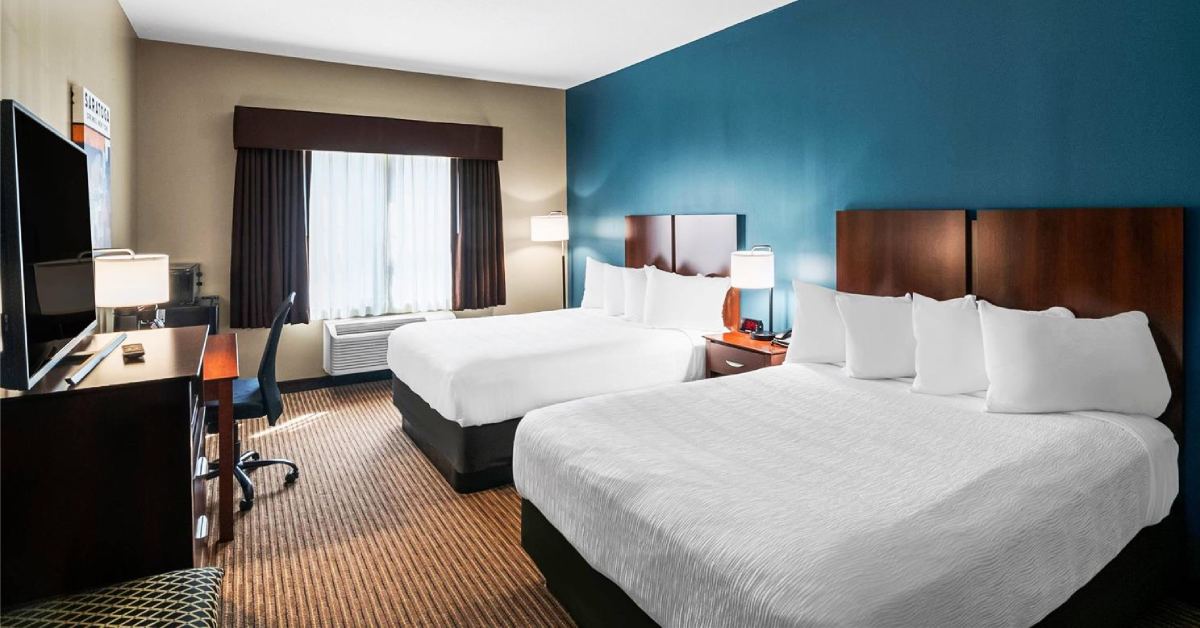 two queen beds in a hotel room