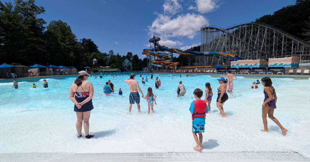 wave pool with waterslides and roller coaster in the background