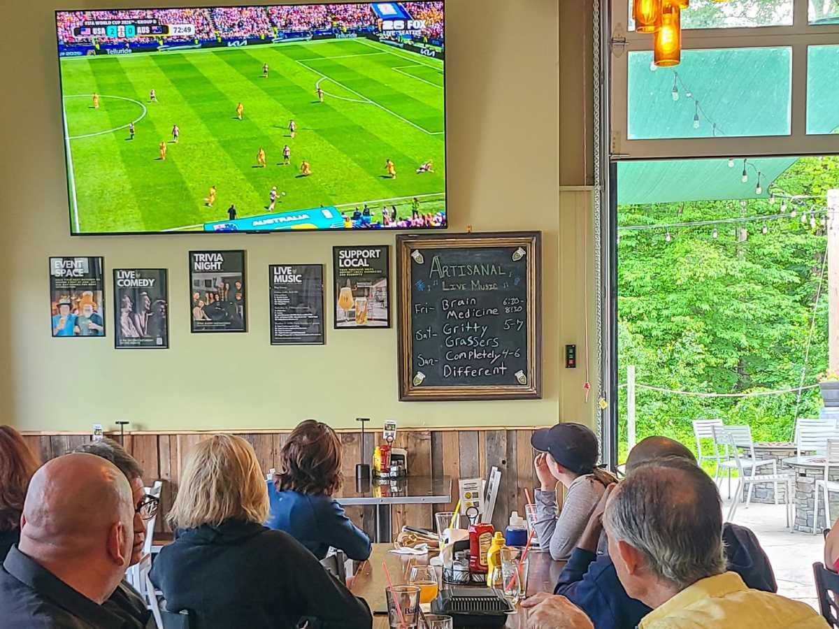 people watching soccer game on the TV