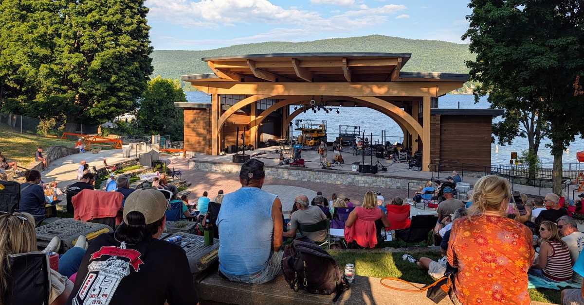 outdoor seating at Lake George's Shepard Park amphitheater with concert on stage