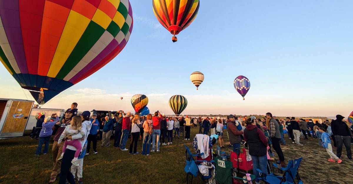 people standing around a balloon festival