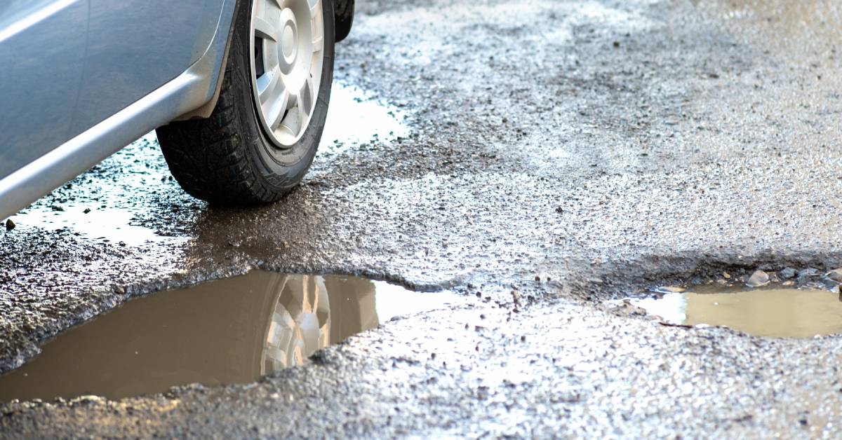 closeup of car near pothole
