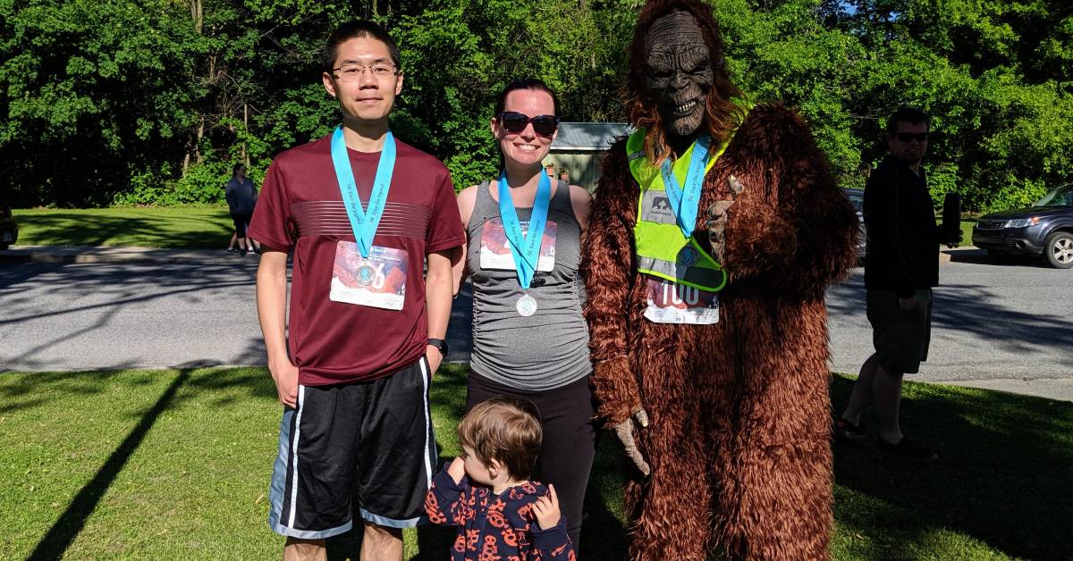 runners pose with bigfoot
