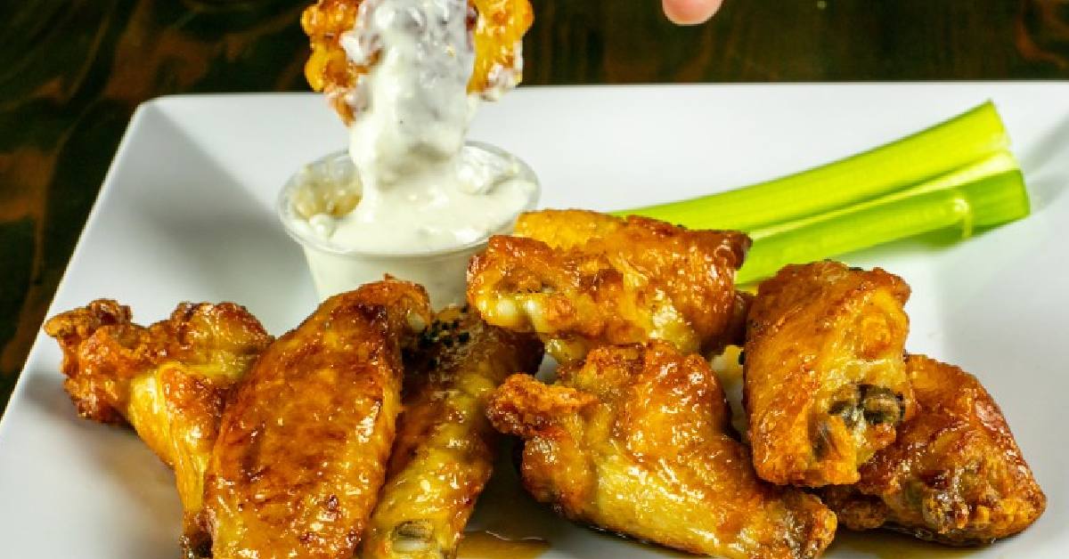 fresh chicken wings with blue cheese on the side