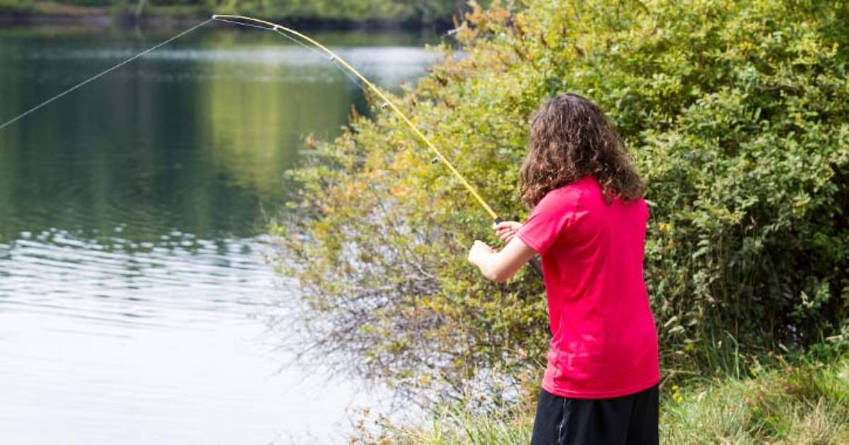 a young person fishing from the shoreline