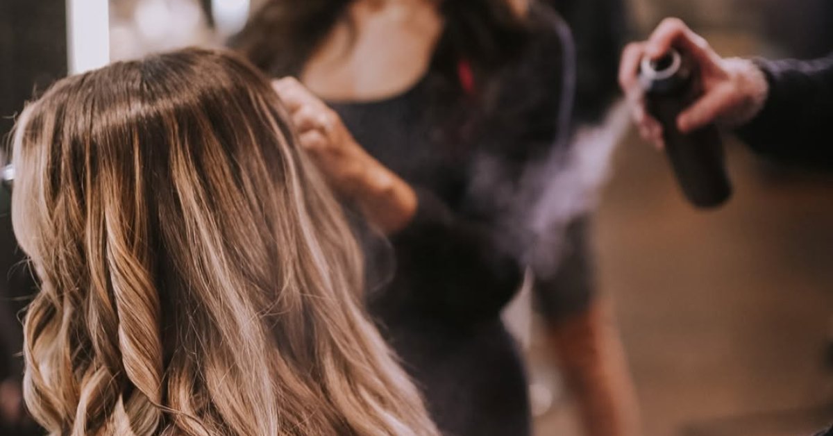 a woman getting hair spray treatment