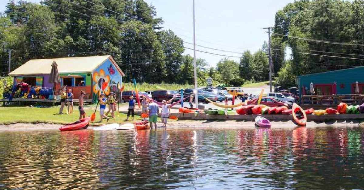 People outside loading into kayaks