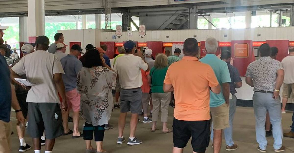 crowd standing in front of horse betting booths