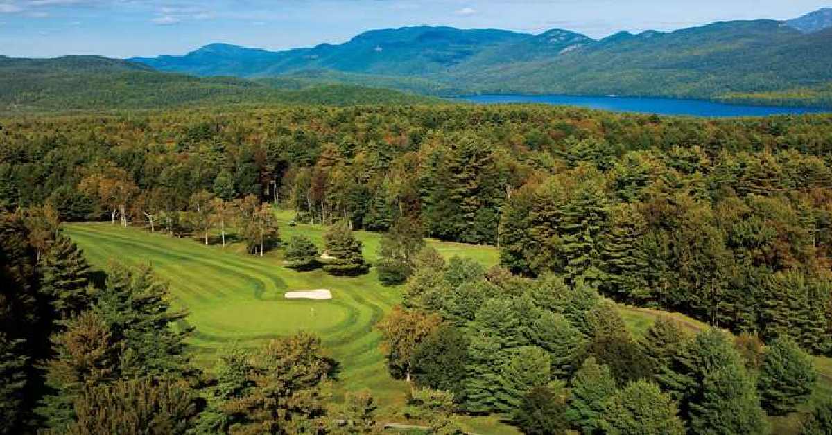 over looking golf green with lake in the background