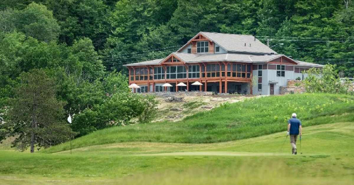 golf green with large venue in the distance