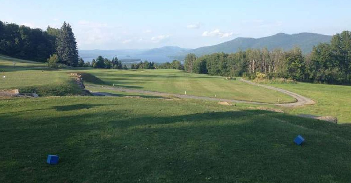 golf green with mountains in the distance