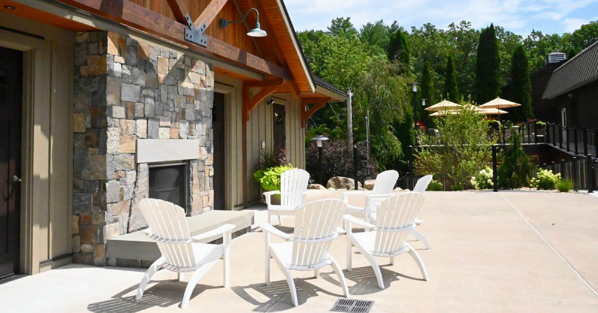 adirondack chairs around an outdoor fireplace