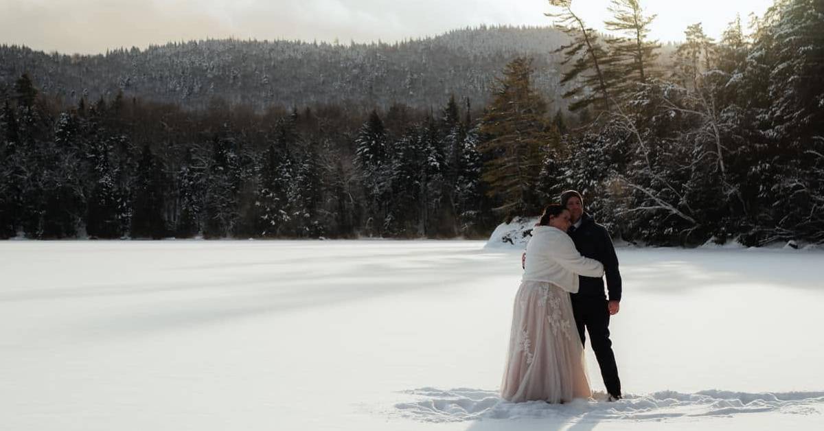 bride and groom in field in winter
