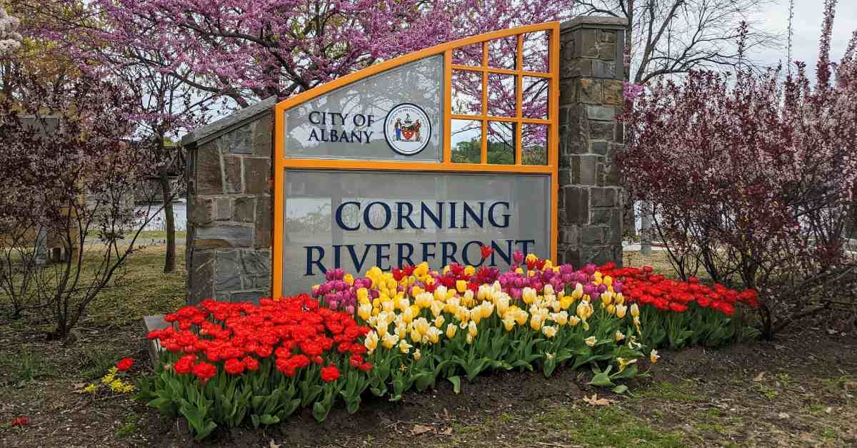 corning riverfront sign with flowers