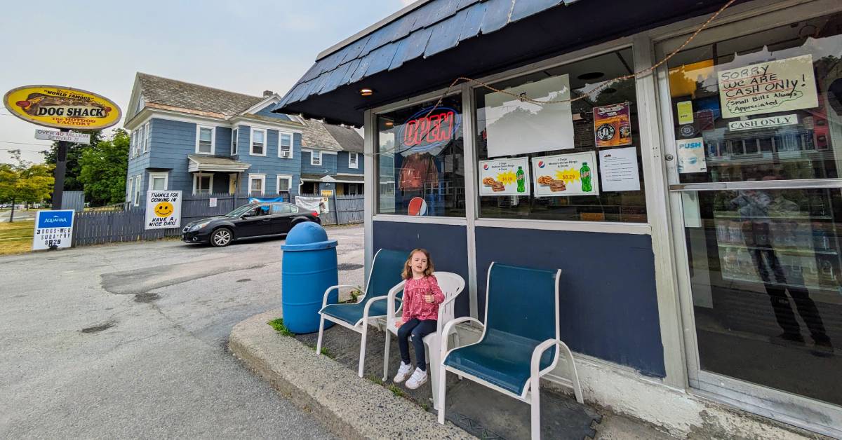 little girl outside the dog shack
