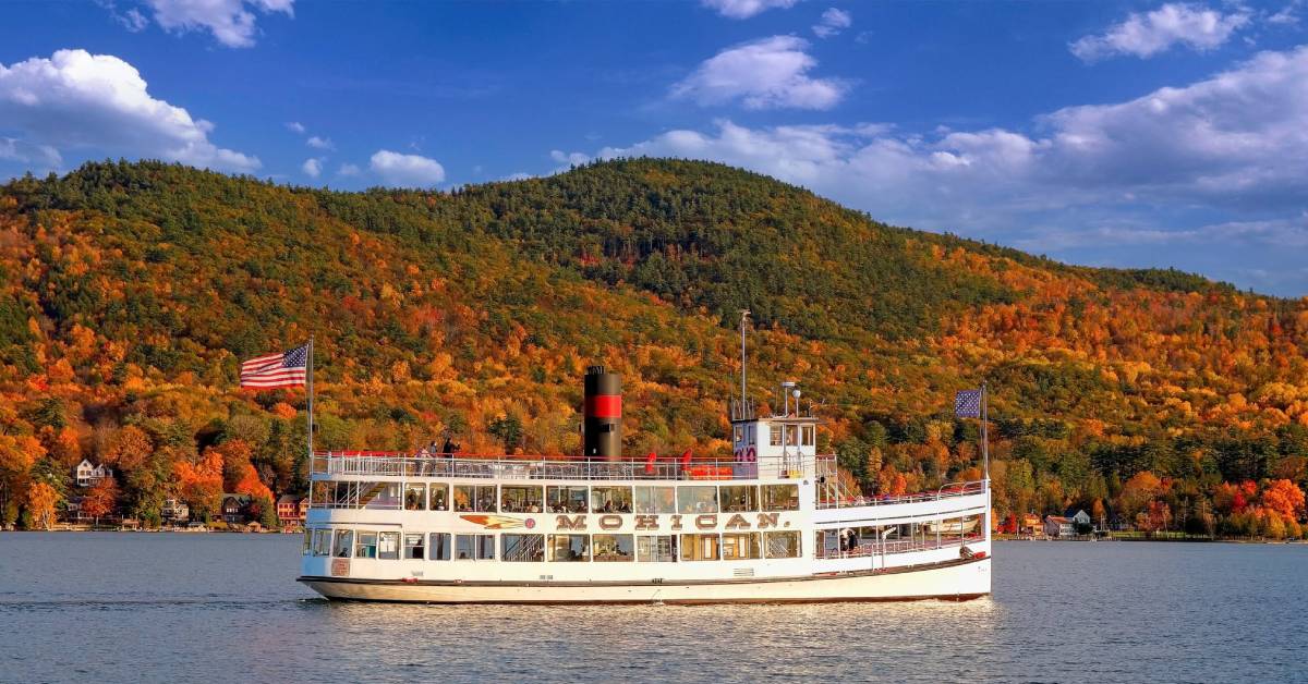 mohican cruise ship going by fall foliage on mountain