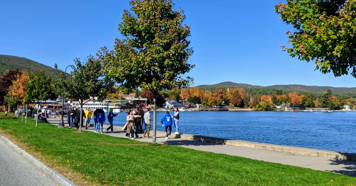 people walking near lake george in october