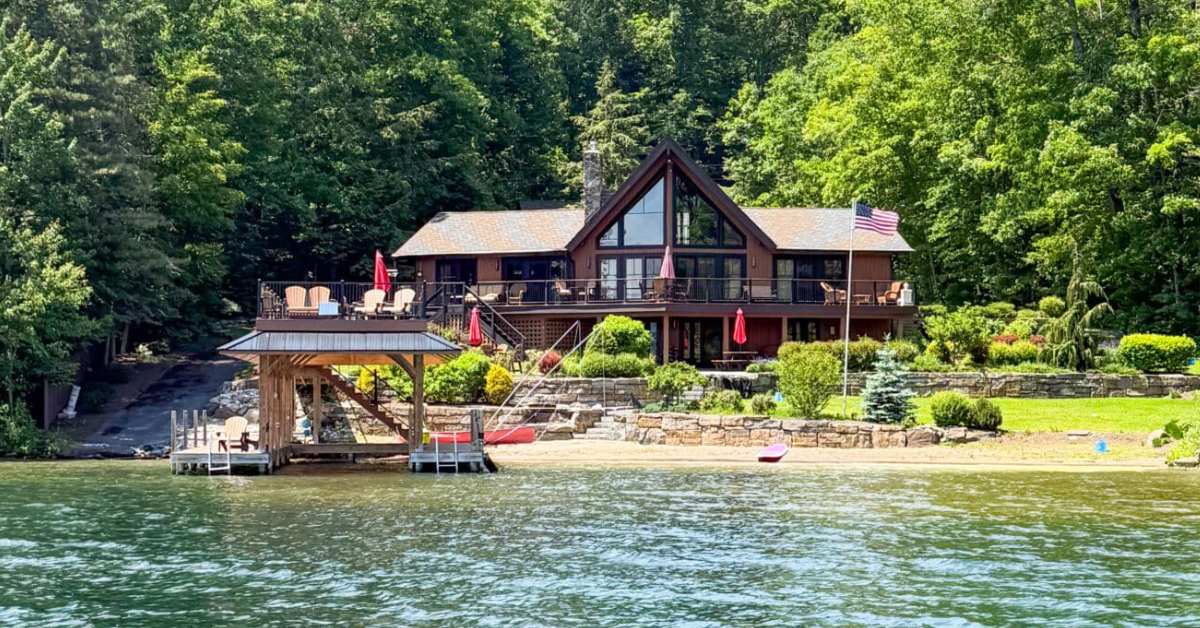 large waterfront home with a two story boat dock