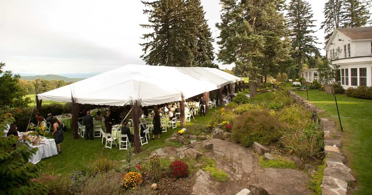 a wedding reception tent by a golf course building