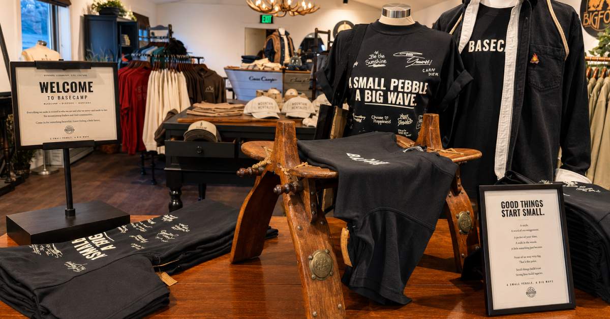 Basecamp apparel and merchandise display featuring shirts, hats, and gift items inside the Bolton Landing store