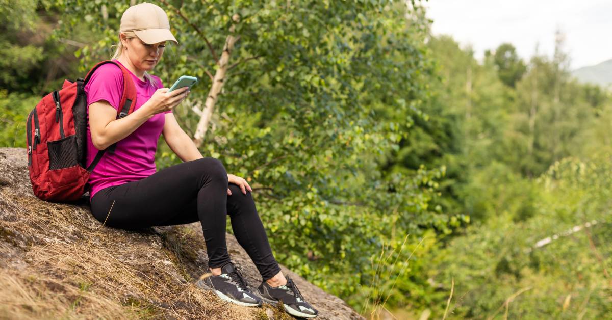 woman on phone on rock