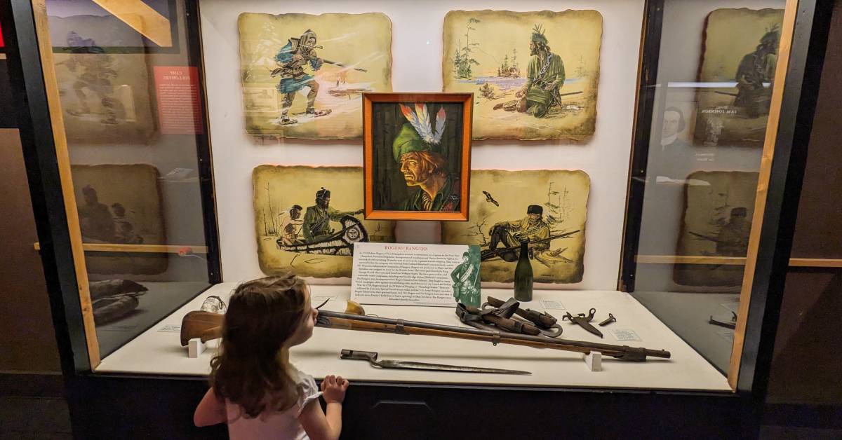 little girl looking at display at fort william henry