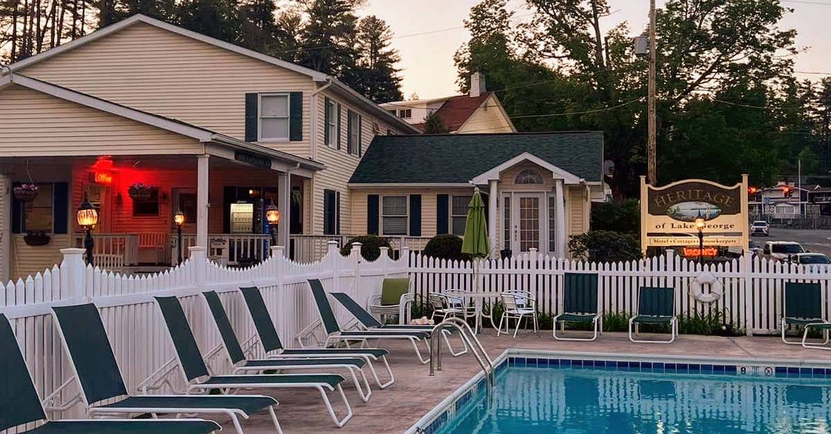 heritage of lake george exterior with sign and pool