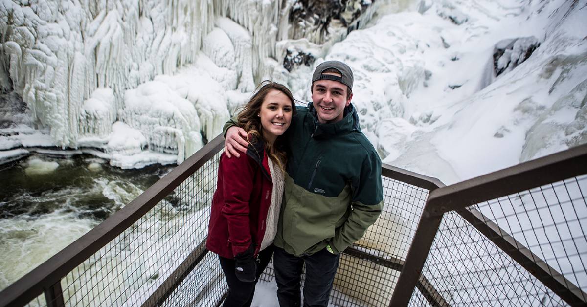 couple poses at high falls gorge in the winter