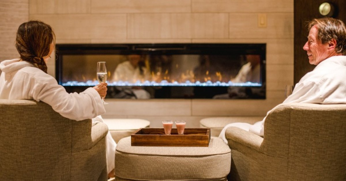 couple sitting by fireplace